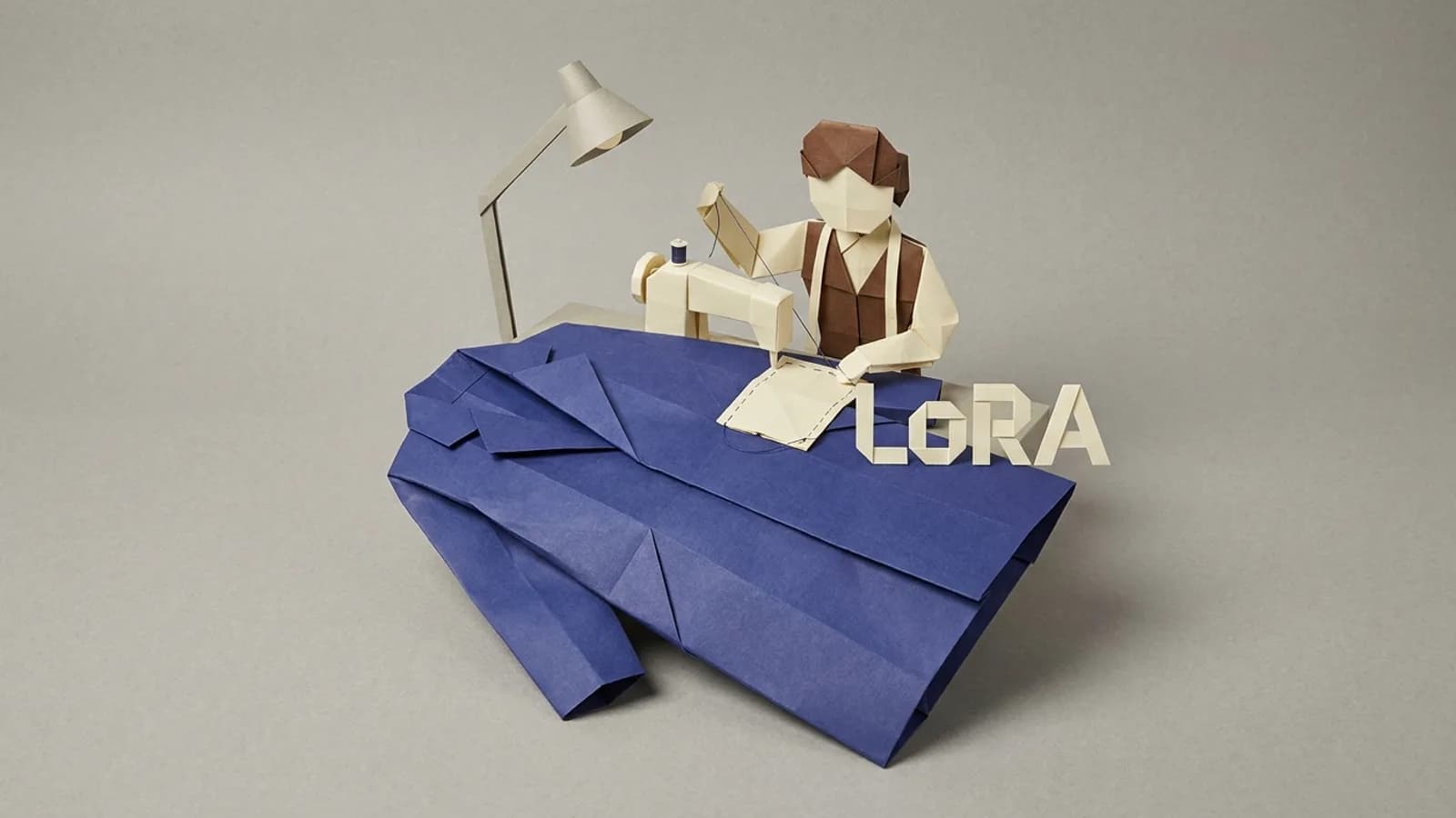 Paper tailor under one lamp sewing a small LoRA patch onto a large finished coat